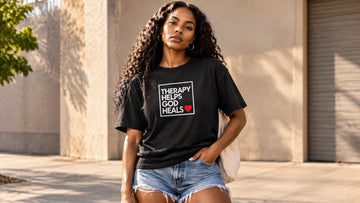 Model wearing a bold retro 90s R&B graphic t-shirt in a clean late-summer streetwear setting