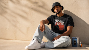 Model wearing bold retro-inspired summer streetwear in a clean editorial setting