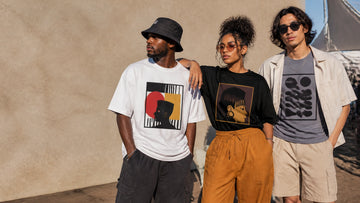 Three friends wearing retro-inspired streetwear at a sunny summer music festival