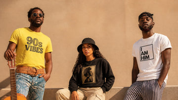 Three friends wearing colorful summer streetwear inspired by 90s R&B and hip-hop style