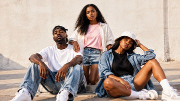 Three friends wearing inclusive retro R&B-inspired summer streetwear in warm natural light
